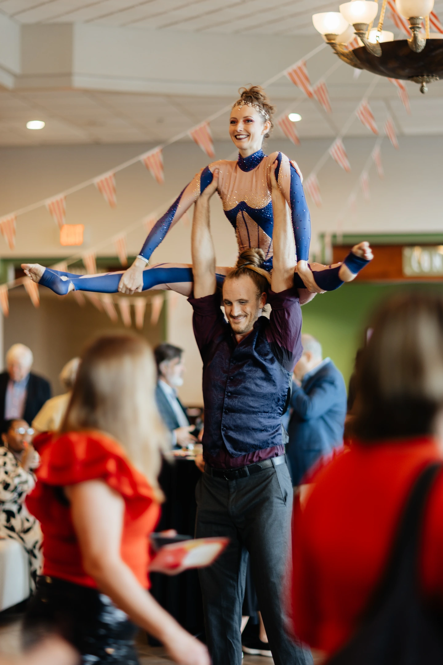 Acrobats striking a death defying pose at a cocktail party