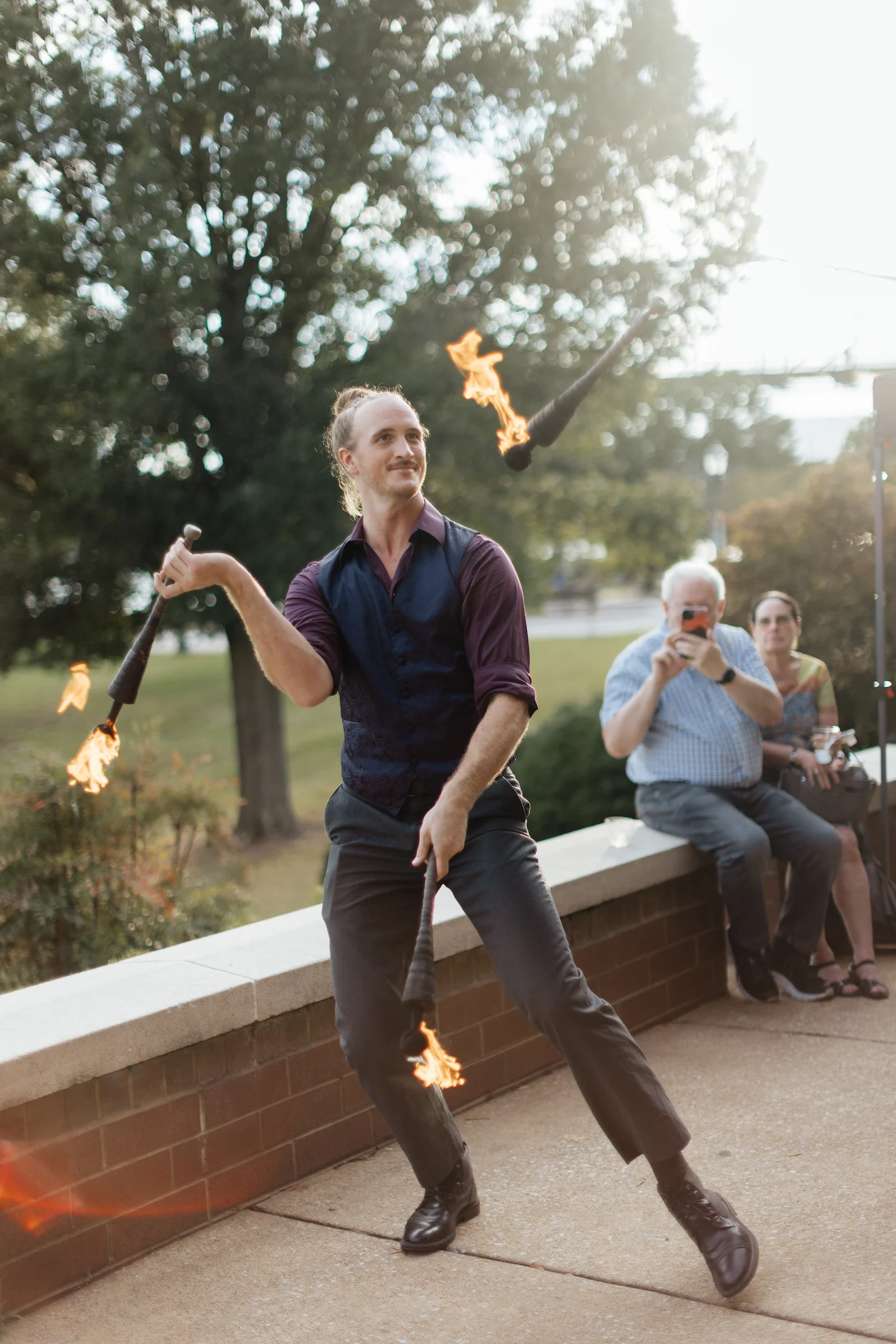 Juggler with 3 flaming torches at a fundraiser