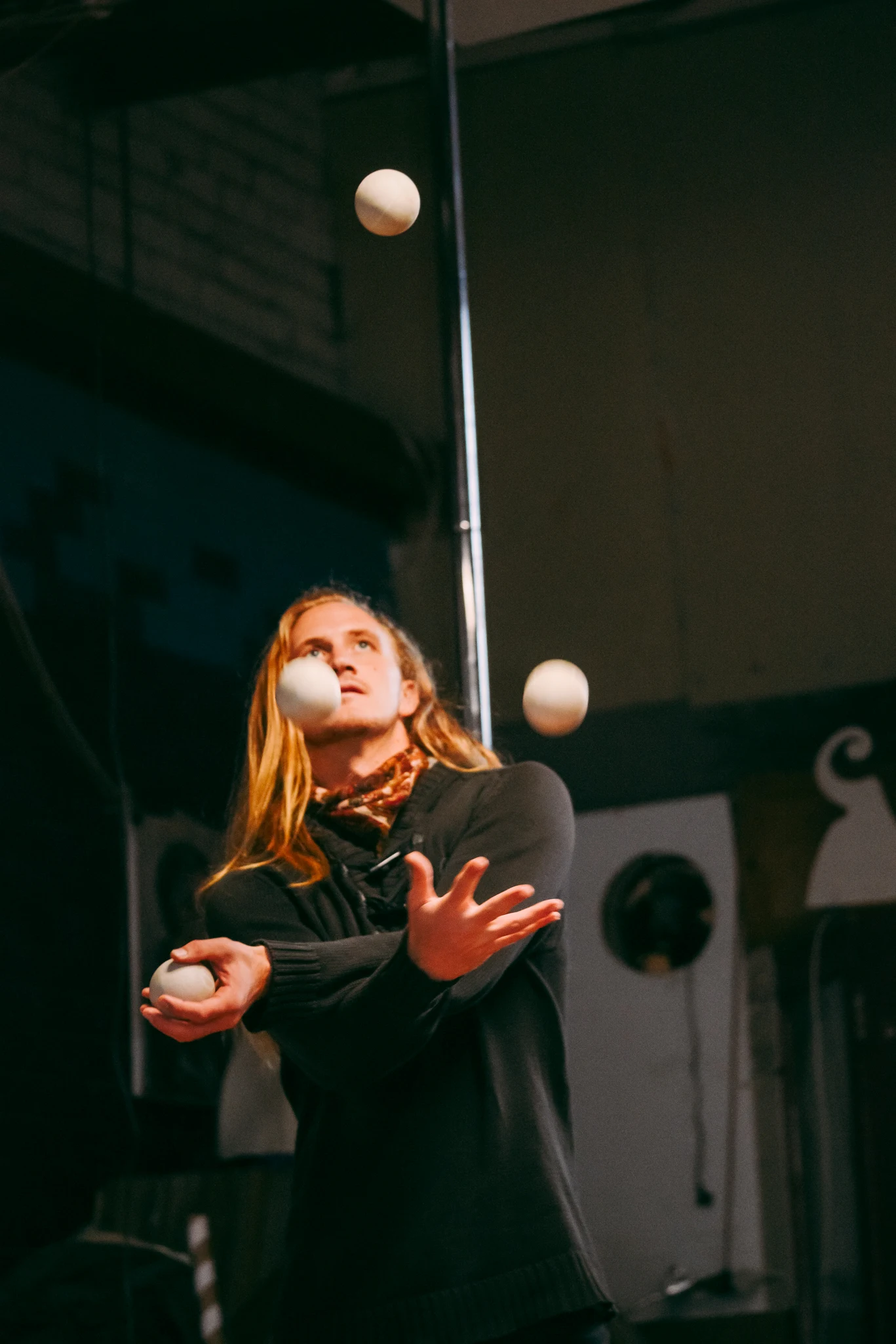 Juggler performing with five balls