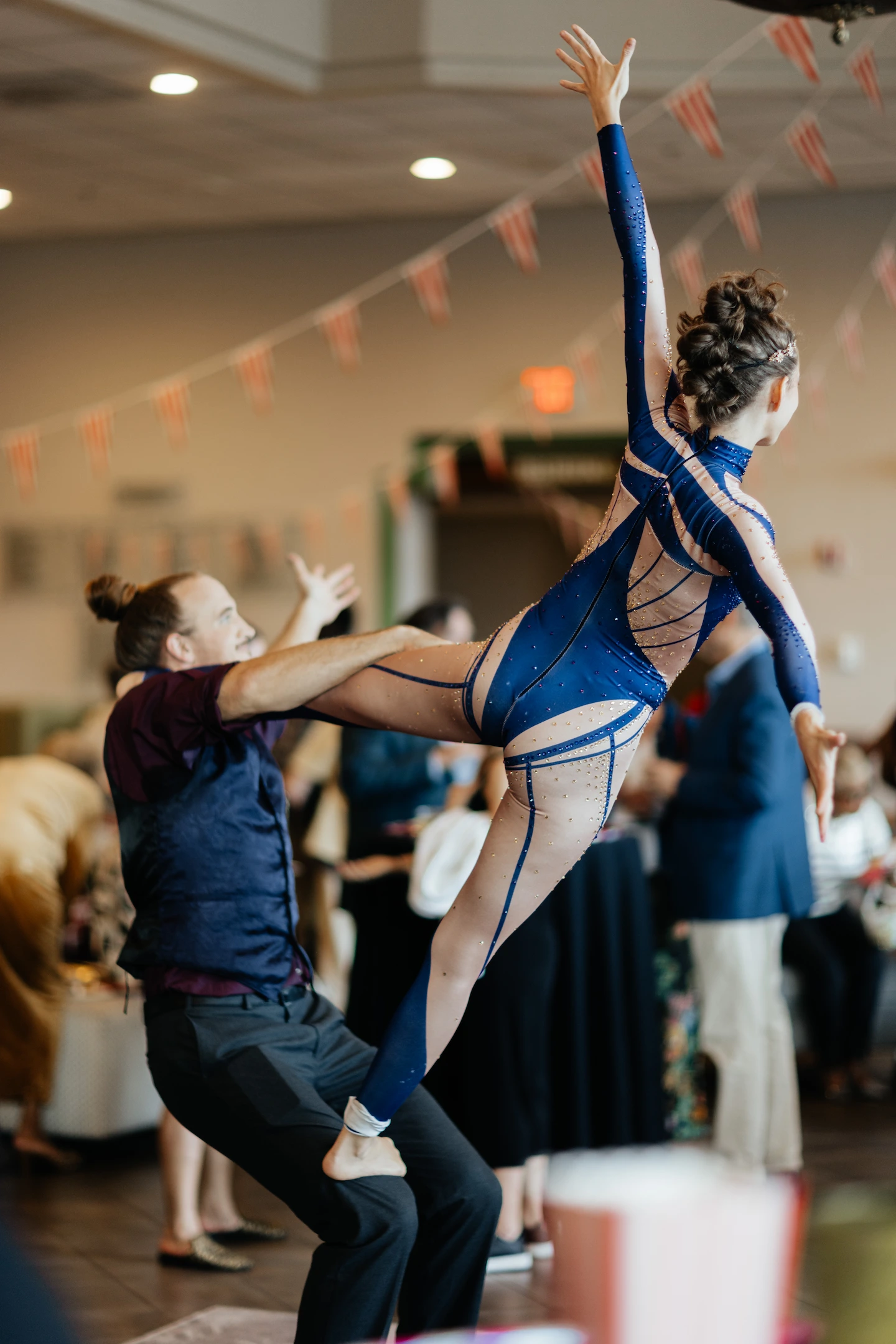 Partner acrobats performing a flag pose at a private event