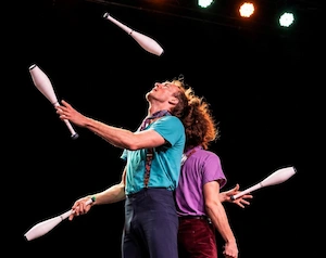 Partner club jugglers on stage